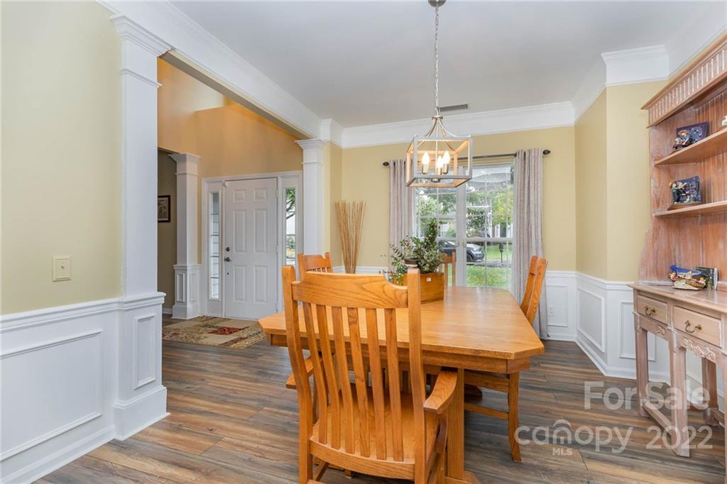 154 Coronilla Road Mooresville, NC 28117 - Photo 7 of 38 a view of a dining room with furniture window and wooden floor