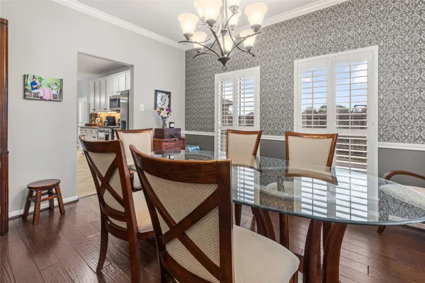a dining room with furniture and wooden floor