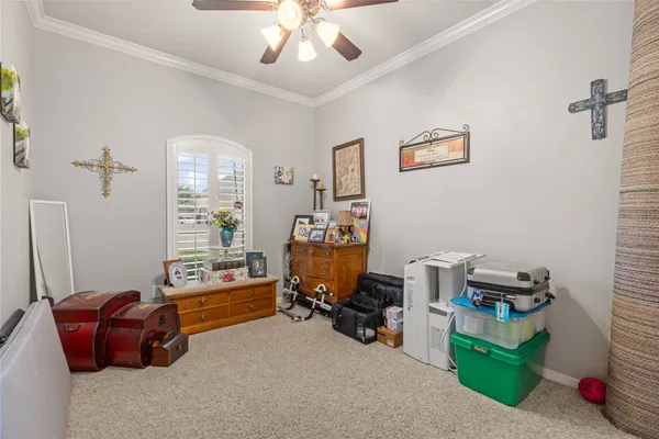 a bedroom with bed and a chandelier