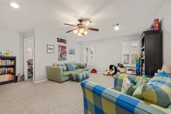 a living room with furniture a couch and a bookshelf