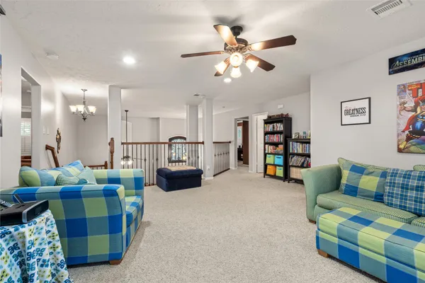 a living room with furniture and kitchen view