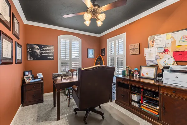 a livingroom with workspace and a window