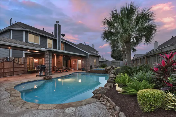 a view of a house with swimming pool and sitting area