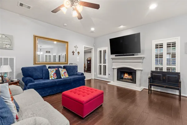 a living room with furniture a flat screen tv and a fireplace