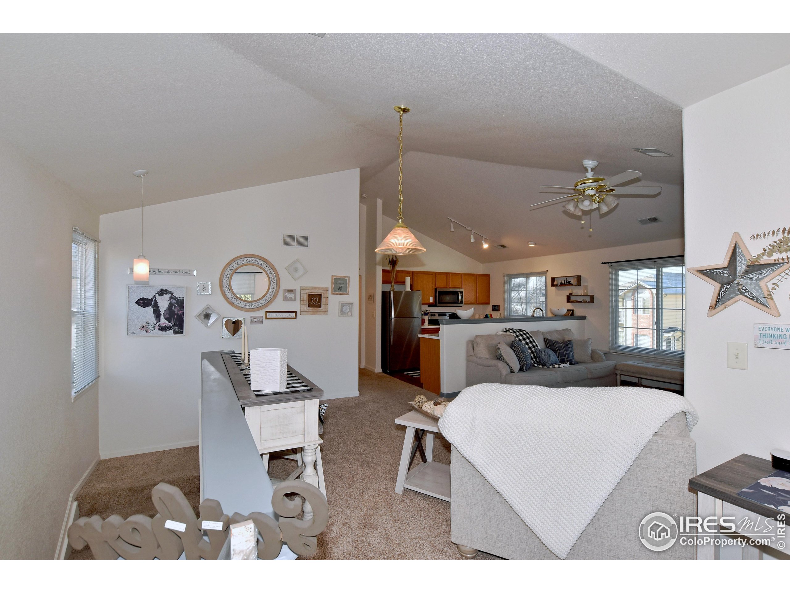 5151 West 29th Street Greeley, CO 80634 - Photo 14 of 40 a living room with furniture and a clock