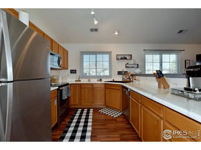 a kitchen with stainless steel appliances granite countertop a refrigerator sink and cabinets