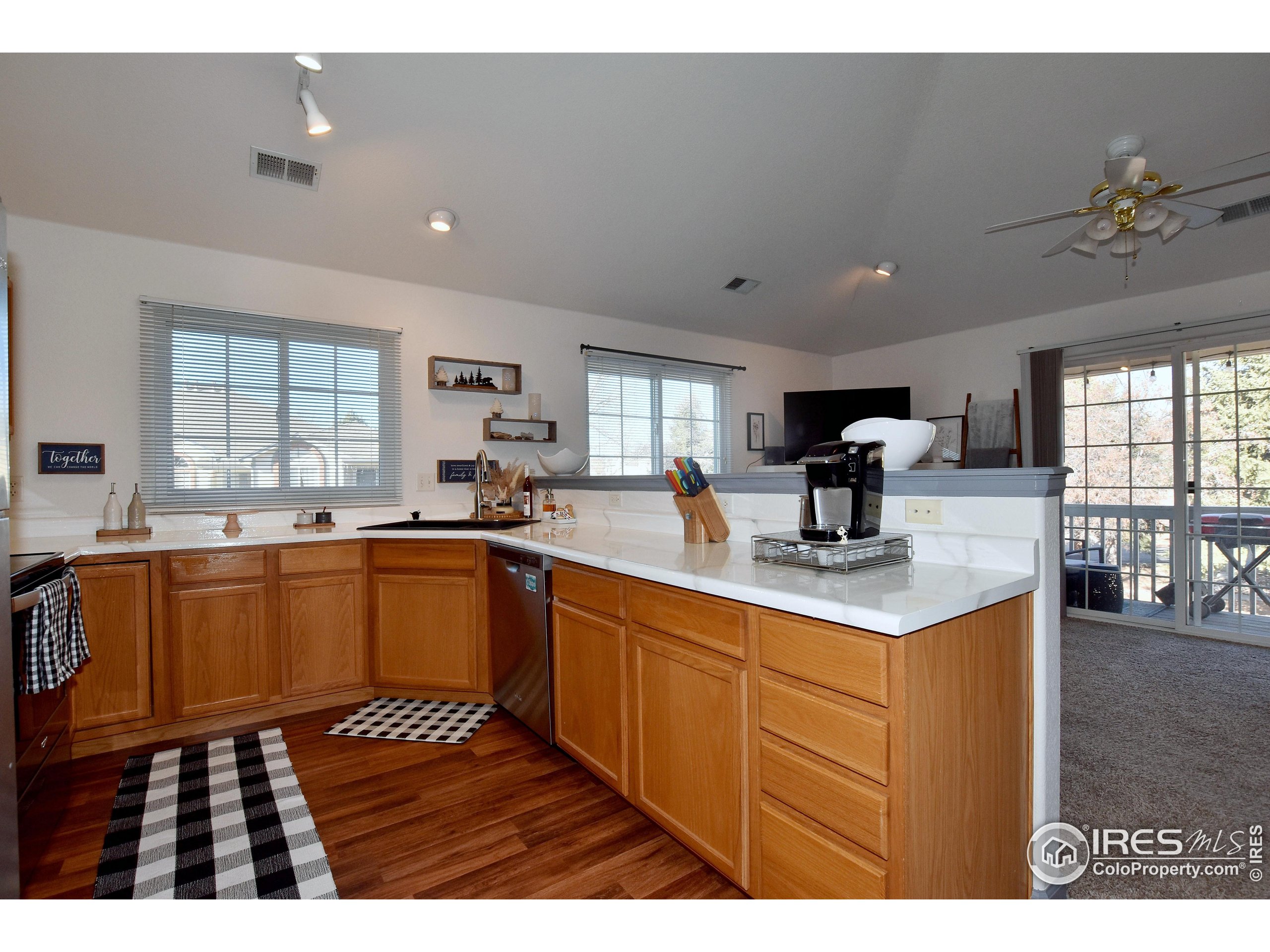 5151 West 29th Street Greeley, CO 80634 - Photo 17 of 40 a kitchen with sink cabinets and window