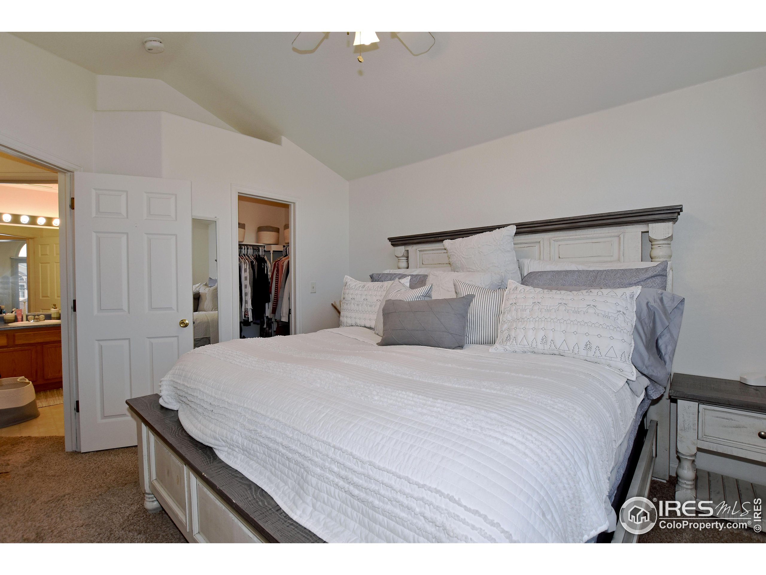 5151 West 29th Street Greeley, CO 80634 - Photo 22 of 40 a bedroom with a bed and a chandelier
