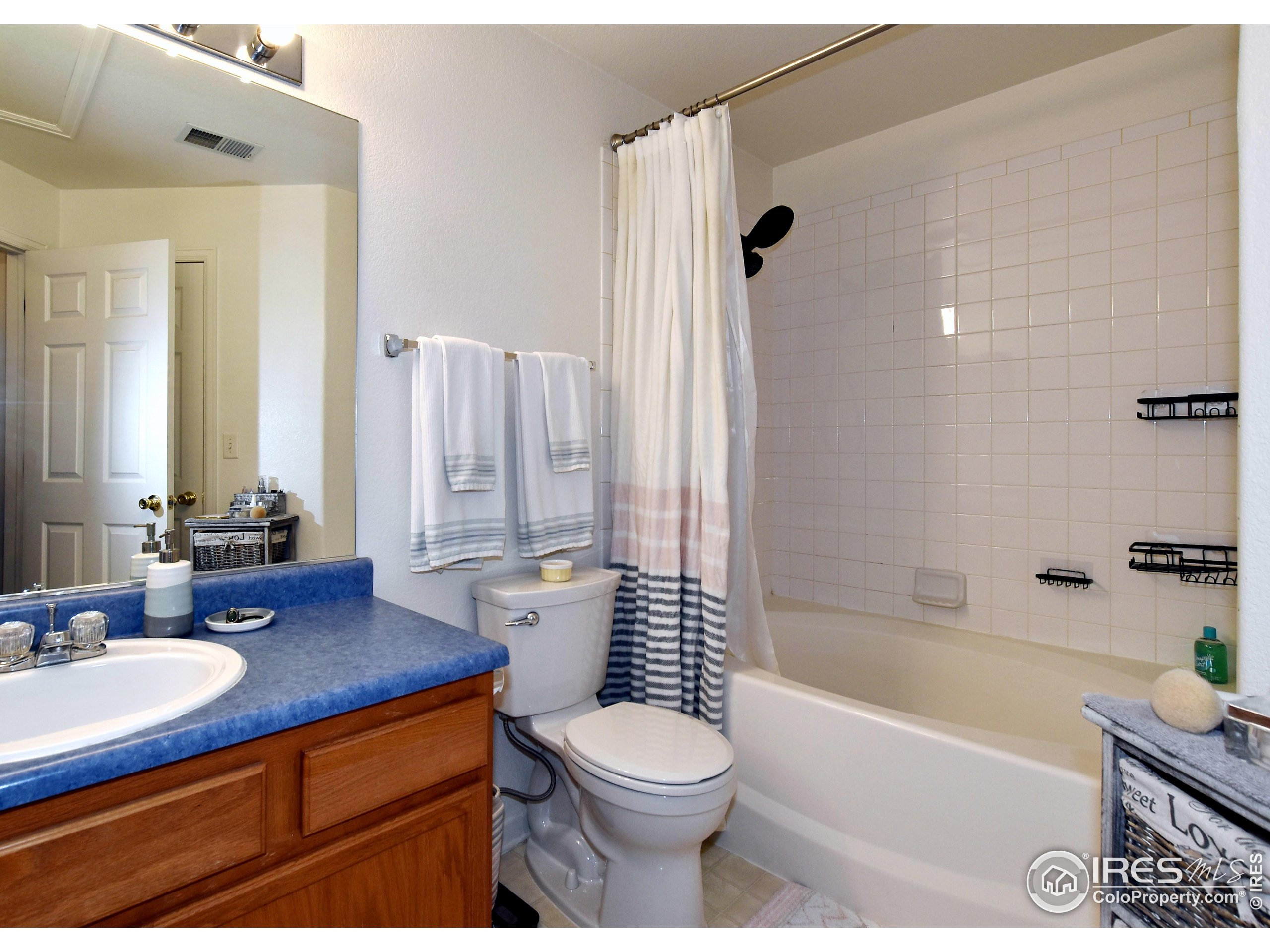 5151 West 29th Street Greeley, CO 80634 - Photo 25 of 40 a bathroom with a sink a toilet and shower