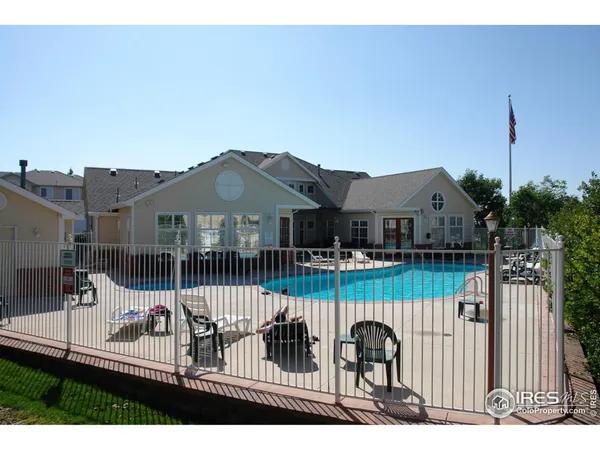 a view of a house with wooden fence