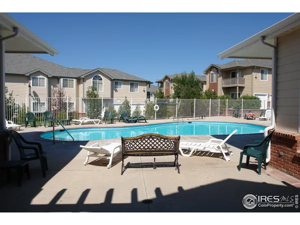 a view of a patio with a table and chairs