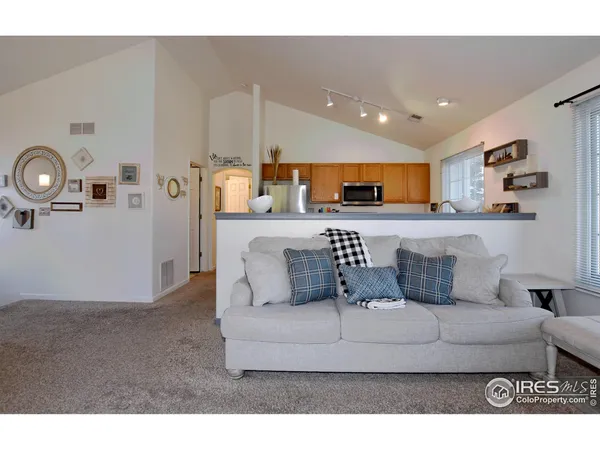 a living room with furniture and kitchen view