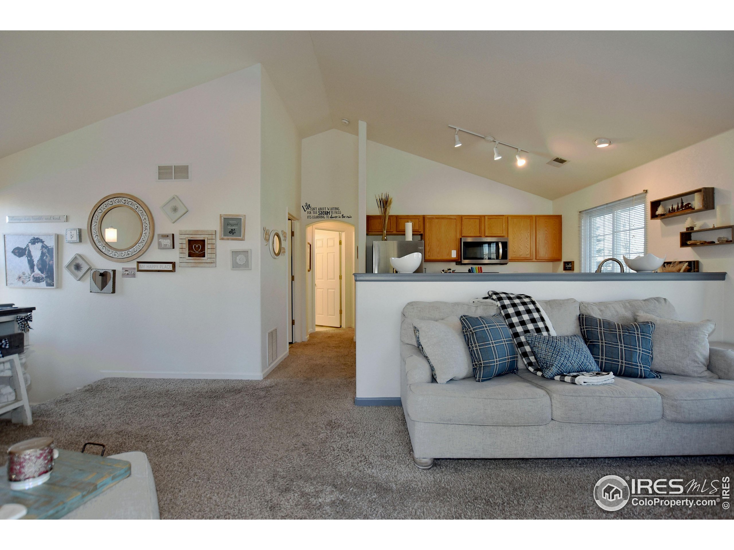 5151 West 29th Street Greeley, CO 80634 - Photo 10 of 40 a living room with furniture and kitchen view