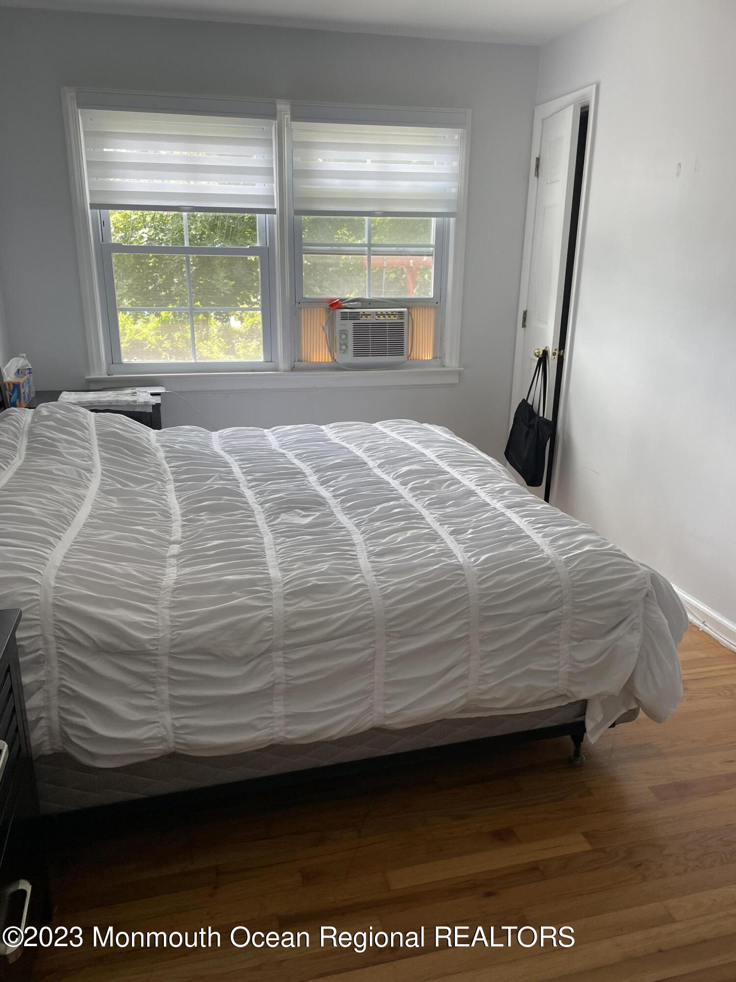98 Neptune Avenue Deal, NJ 07723 - Photo 14 of 14 a bedroom with a bed next to a window
