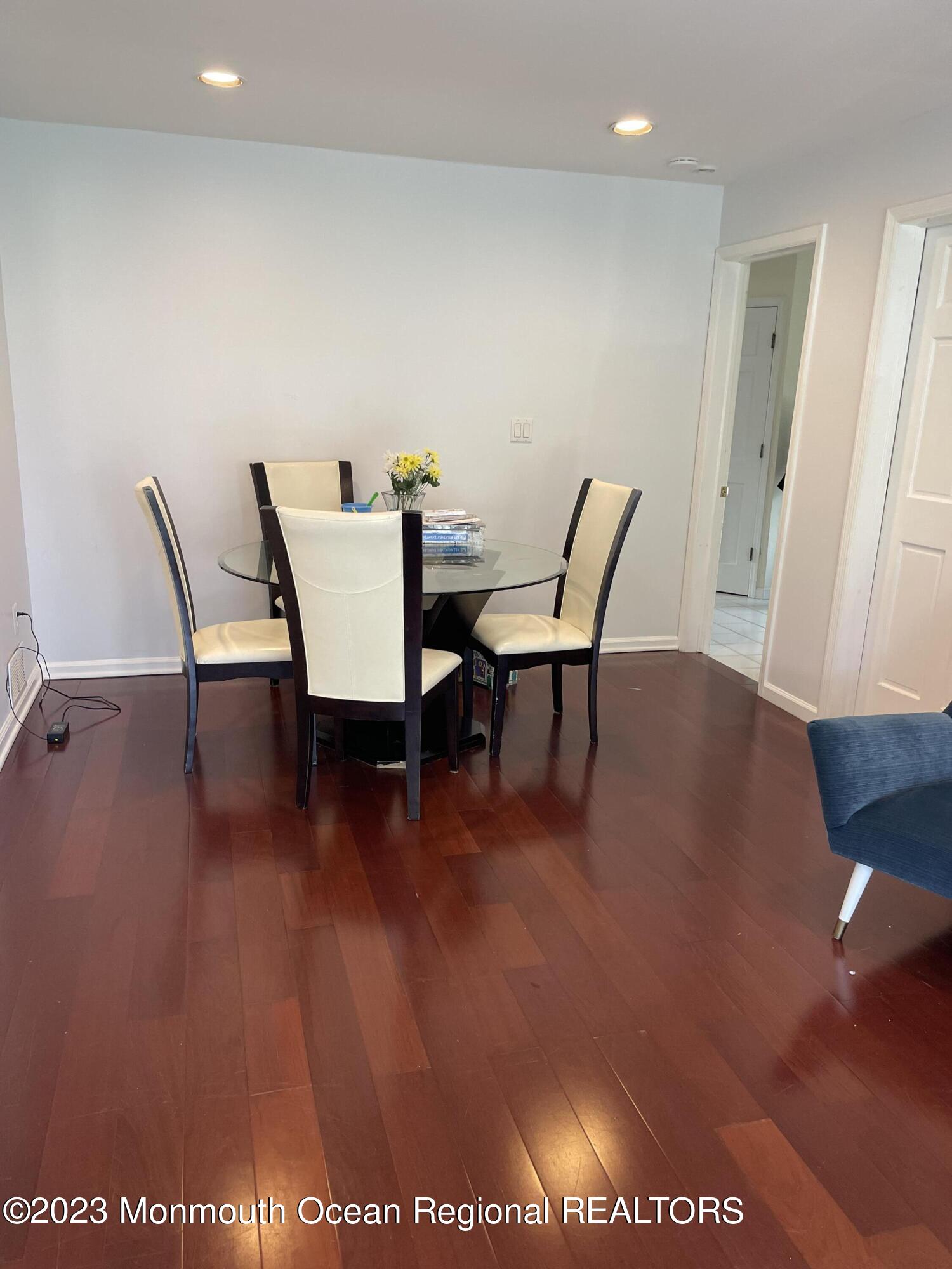 98 Neptune Avenue Deal, NJ 07723 - Photo 4 of 14 a view of a dining room with furniture and wooden floor