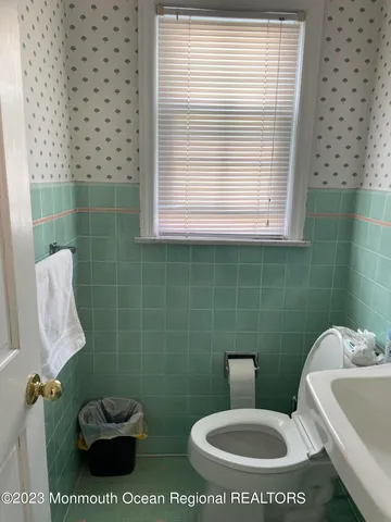 a white toilet sitting next to a bathroom sink