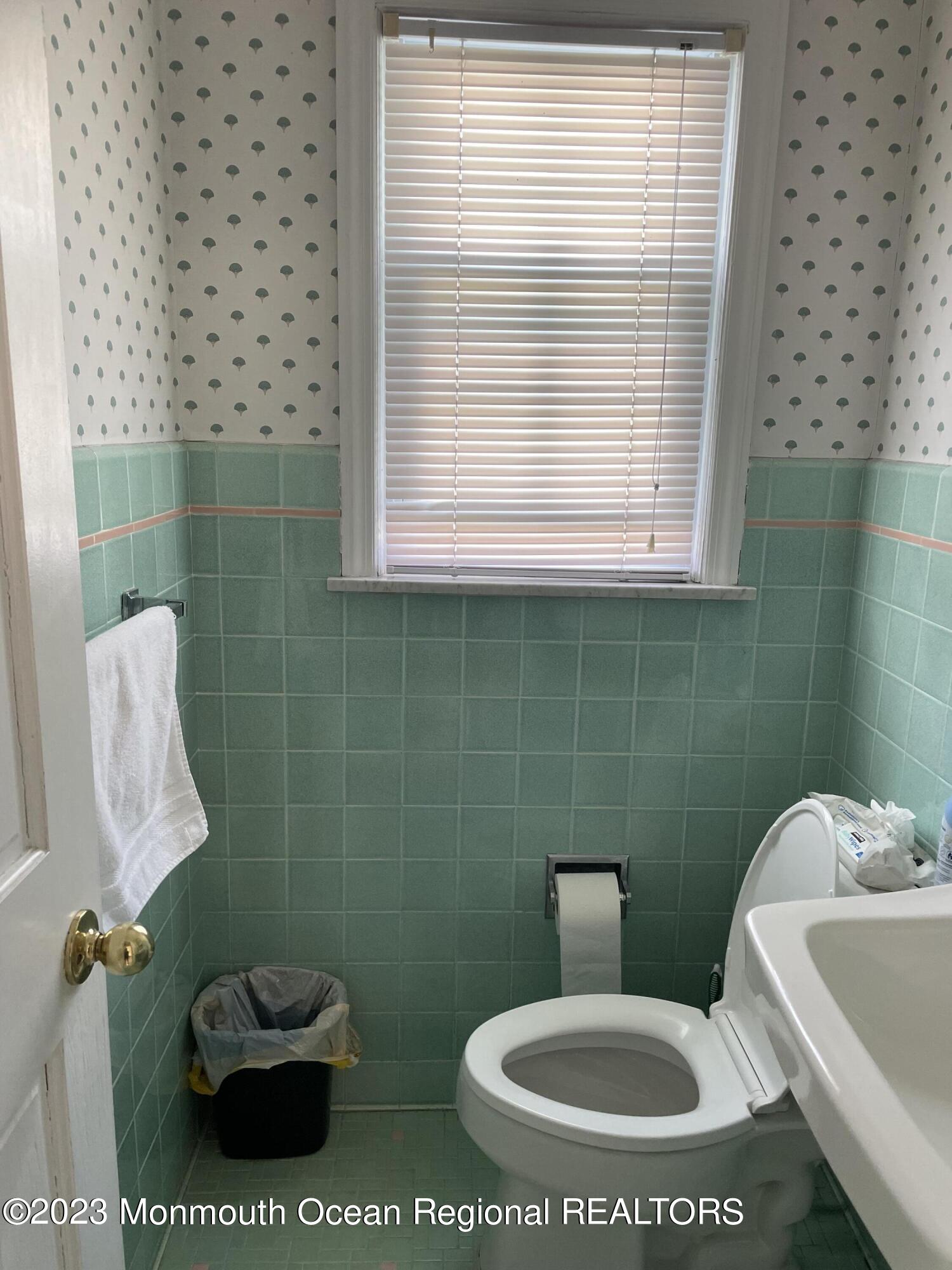 98 Neptune Avenue Deal, NJ 07723 - Photo 6 of 14 a white toilet sitting next to a bathroom sink