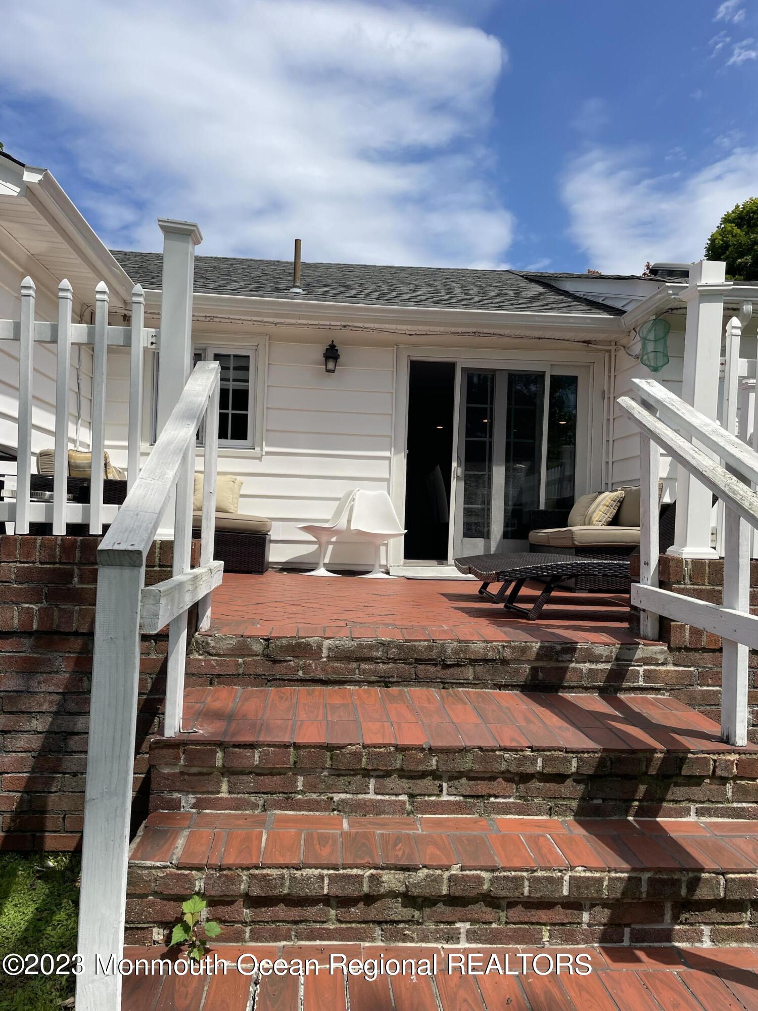 98 Neptune Avenue Deal, NJ 07723 - Photo 8 of 14 a front view of a house with a yard