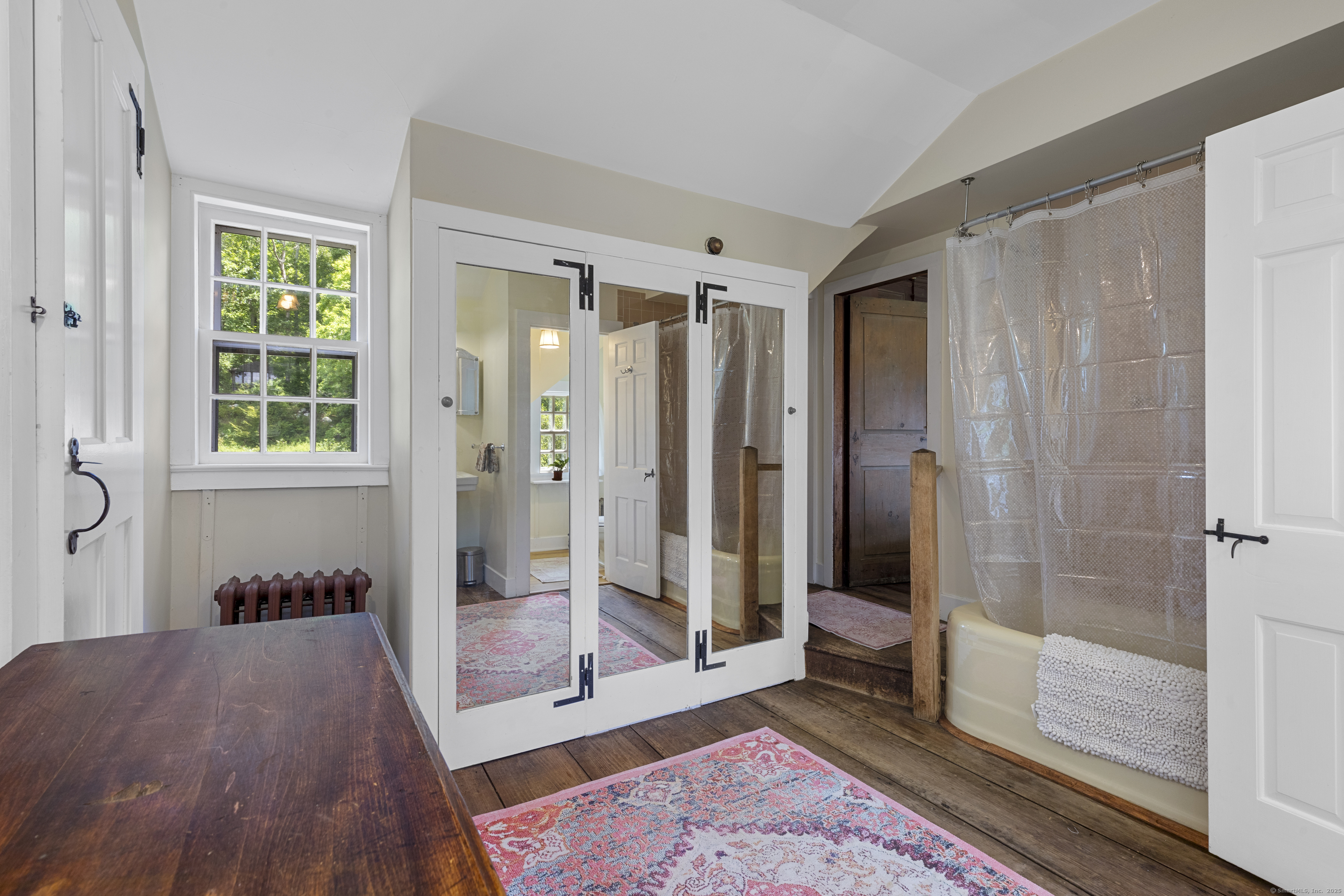 90 Duck Hole Road Guilford, CT 06437 - Photo 29 of 38 a view of a bathroom with a tub shower and mirror