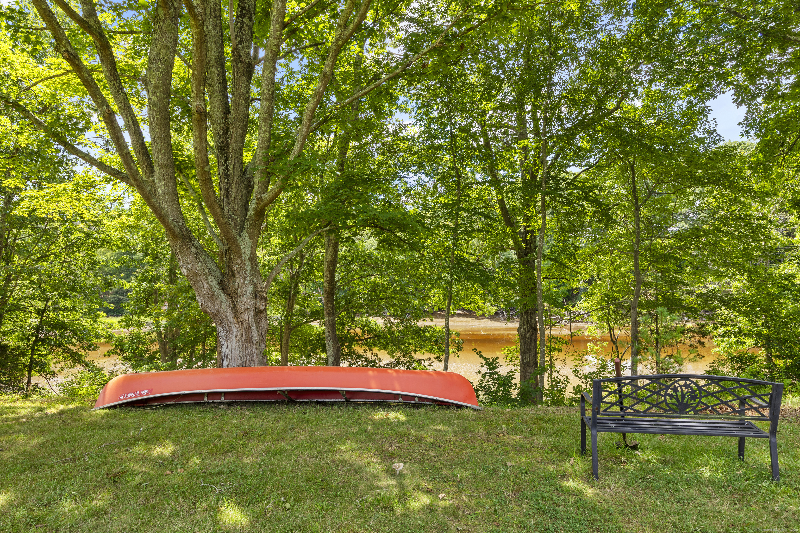 90 Duck Hole Road Guilford, CT 06437 - Photo 38 of 38 a backyard of a house with table and chairs
