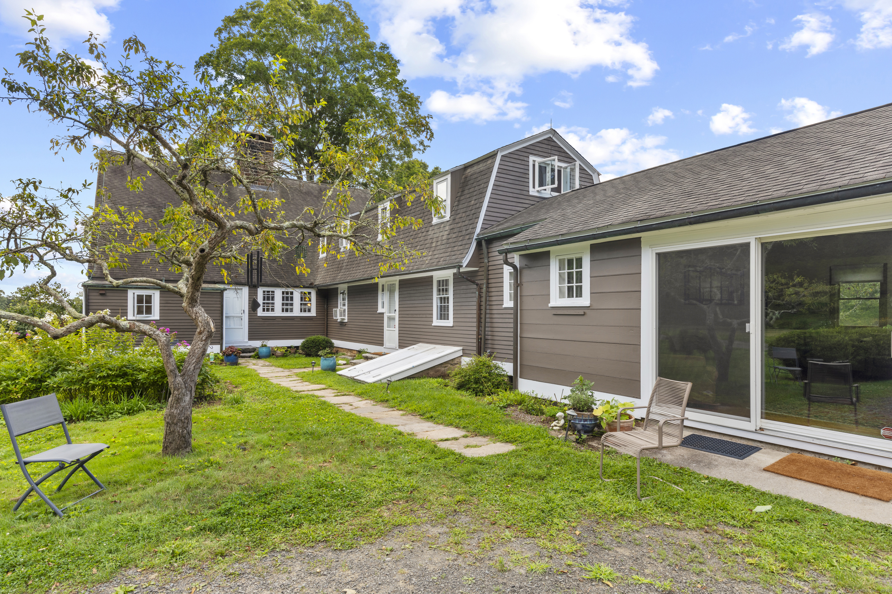 90 Duck Hole Road Guilford, CT 06437 - Photo 6 of 38 a view of a house with a yard porch and sitting area