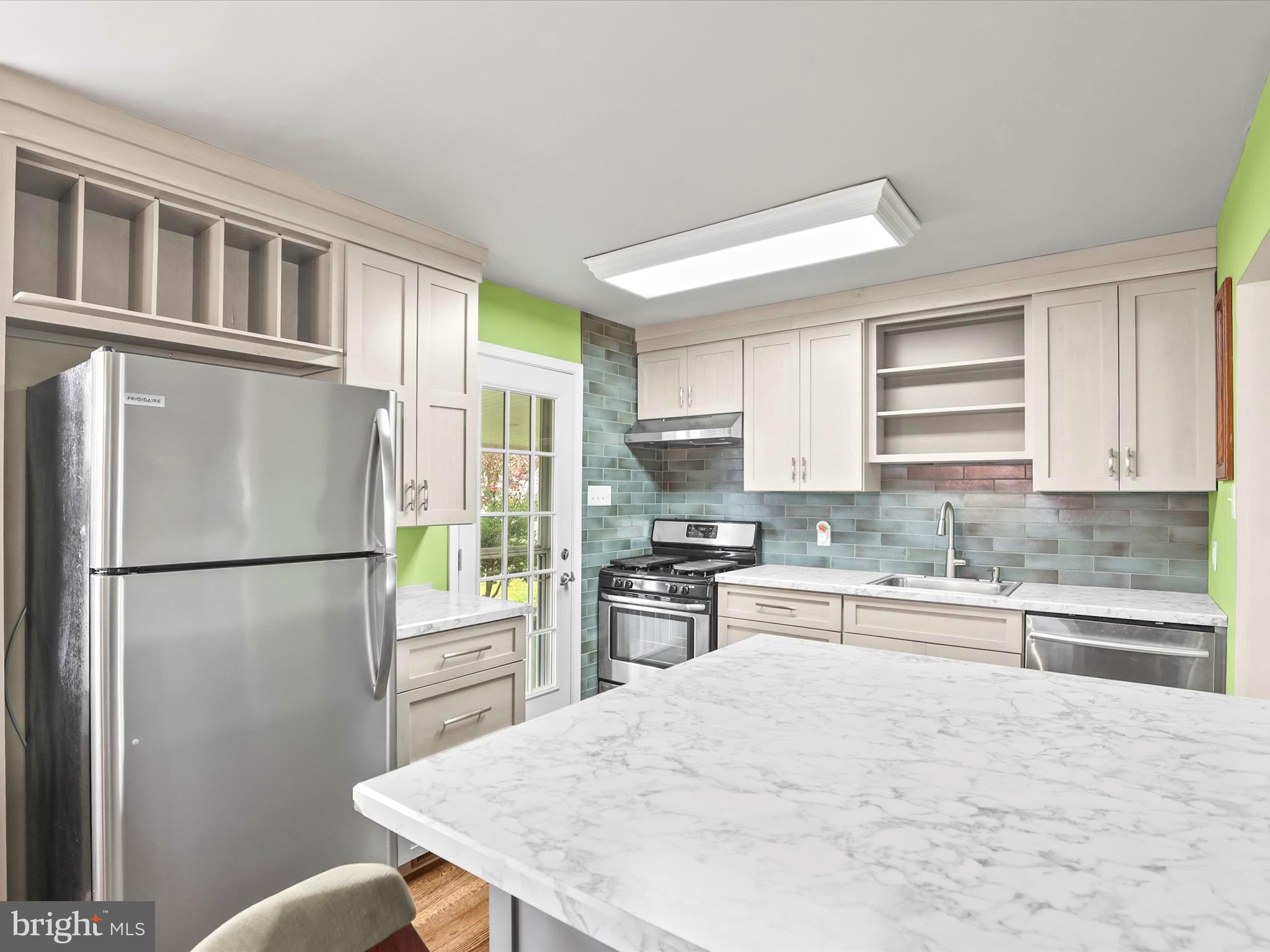 1316 Livingstone Road York, PA 17404 - Photo 20 of 33 a kitchen with stainless steel appliances granite countertop a refrigerator a stove a sink dishwasher a microwave oven with cabinets and wooden floor