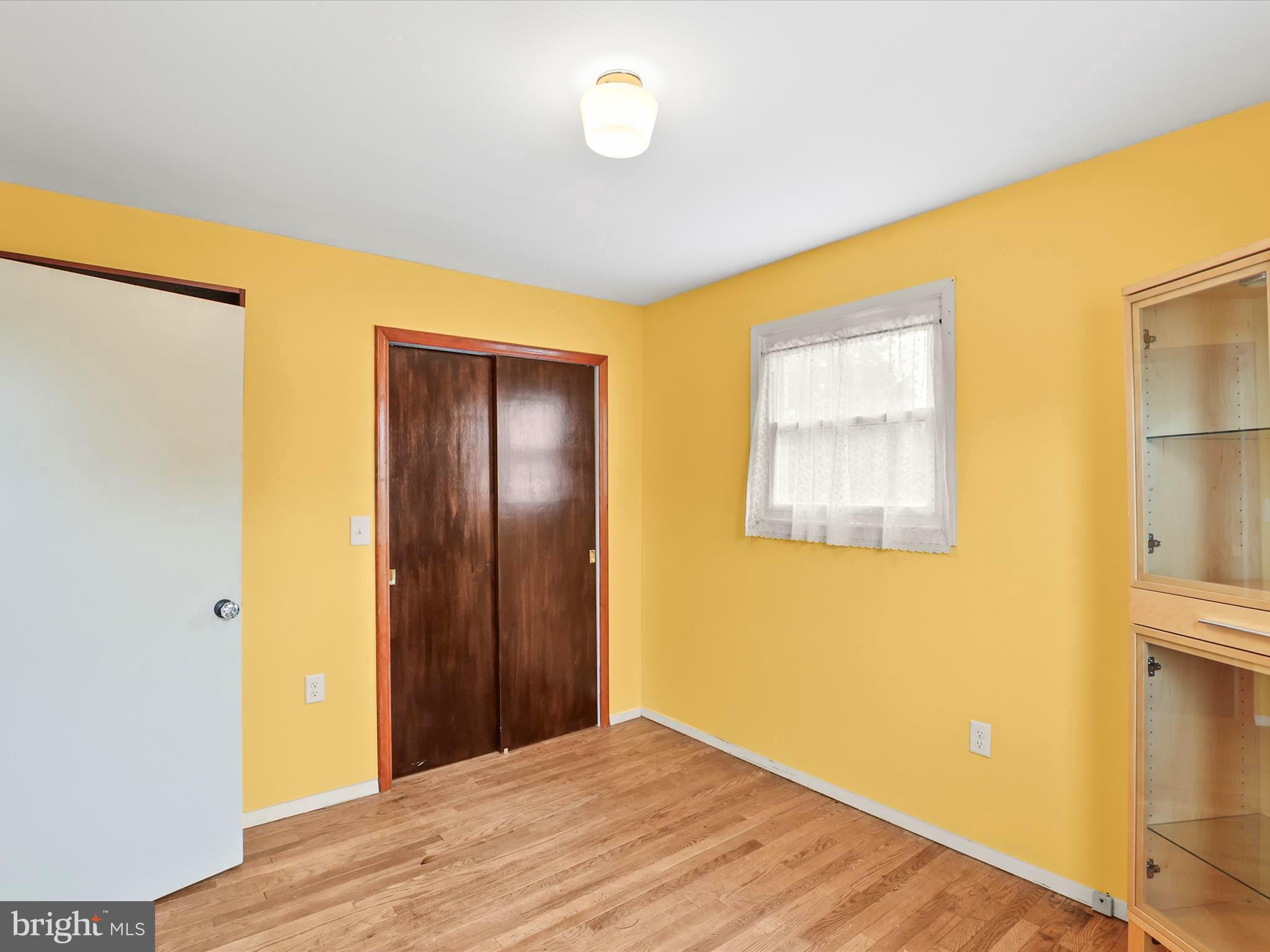1316 Livingstone Road York, PA 17404 - Photo 22 of 33 a view of an empty room with wooden floor and a window