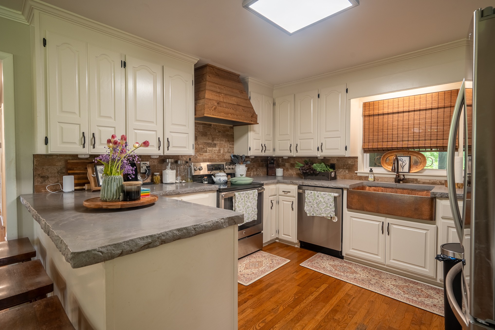 120 Revilo Road Leoma, TN 38468 - Photo 11 of 27 a kitchen with stainless steel appliances granite countertop a sink stove and cabinets
