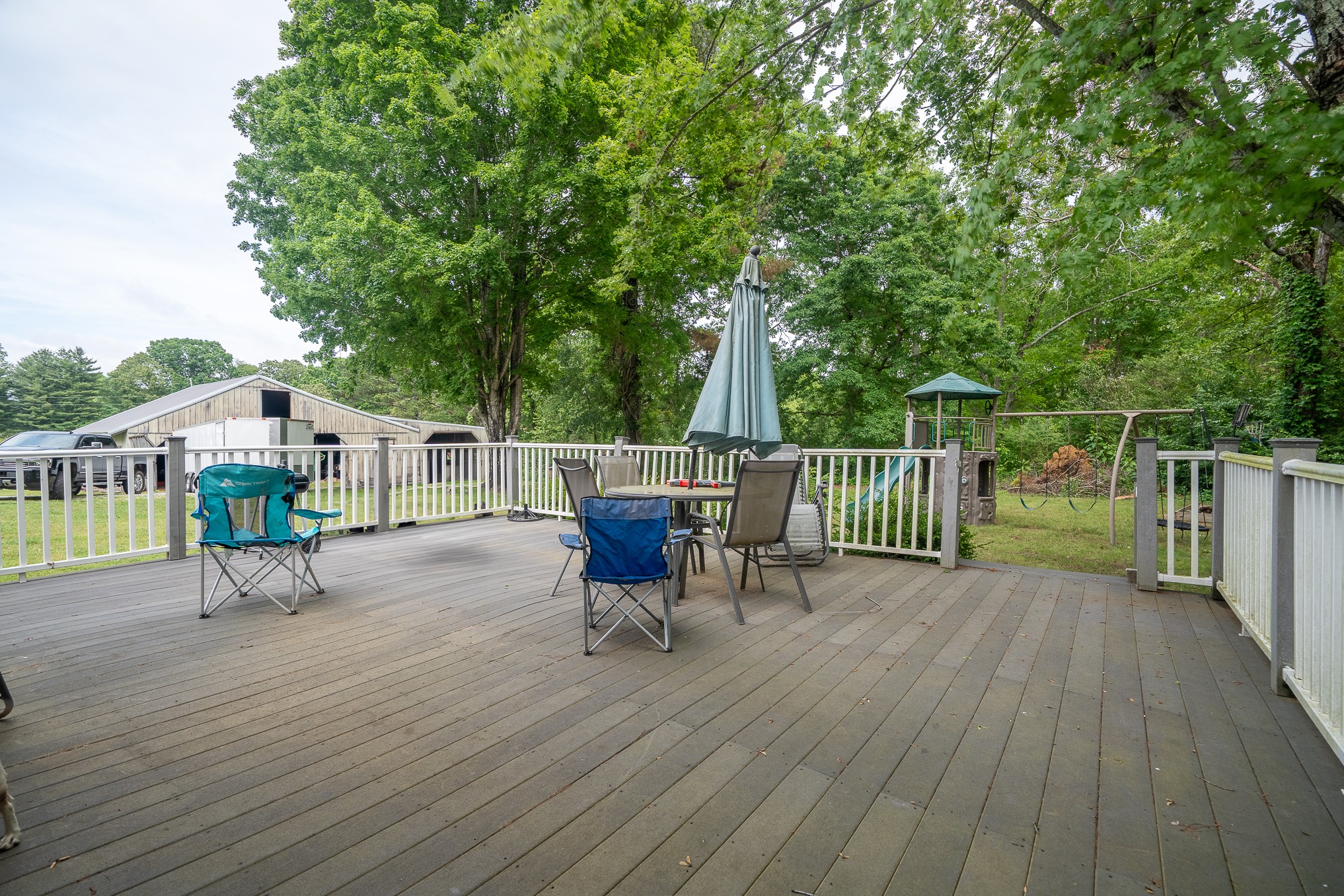 120 Revilo Road Leoma, TN 38468 - Photo 24 of 27 a view of a deck with a table and chairs with wooden floor and fence