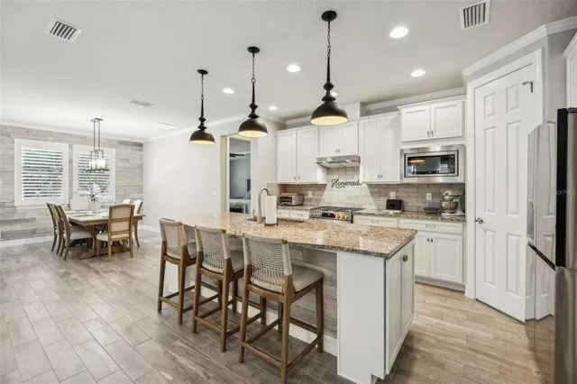 a view of a dining room with furniture wooden floor and chandelier