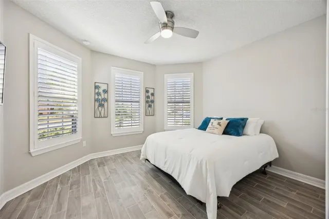 a room with lots of tables a large window and chairs