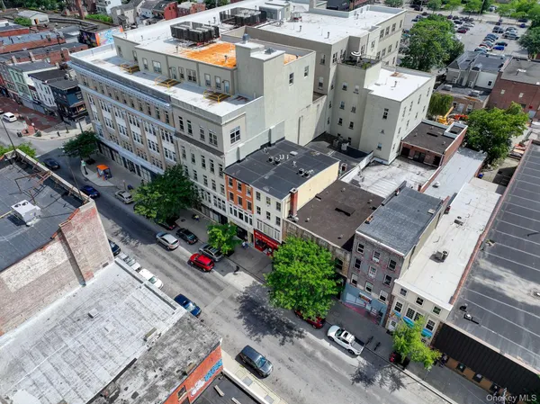 an aerial view of multiple houses with yard