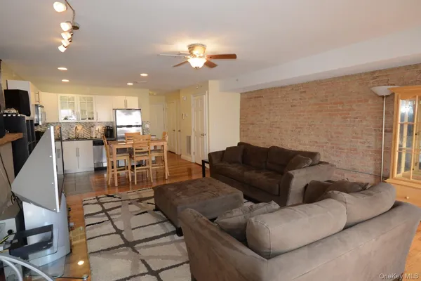 a living room with furniture and kitchen view