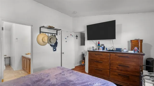 a bedroom with a bed and a television in it
