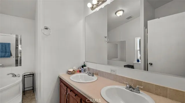 a bathroom with 2 sink and a mirror