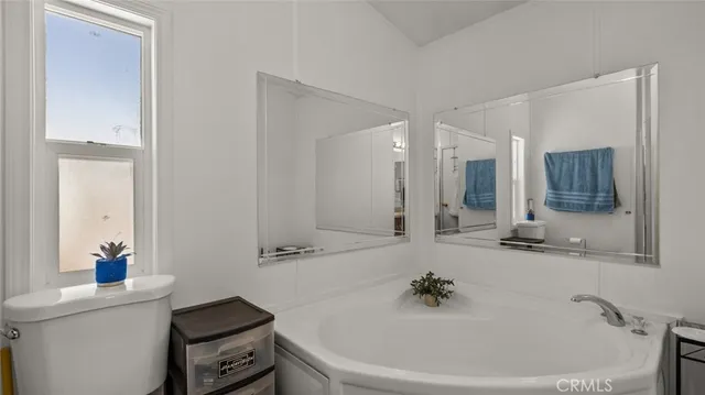 a bathroom with a bathtub sink and mirror