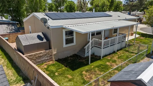 a roof deck with wooden floor and fence