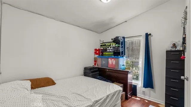 a bedroom with a bed and a dresser