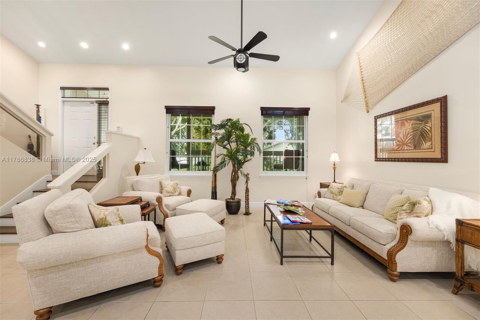 14612 Southwest 153rd Court Miami, FL 33196 - Photo 17 of 26 a living room with furniture a two large window and a ceiling fan