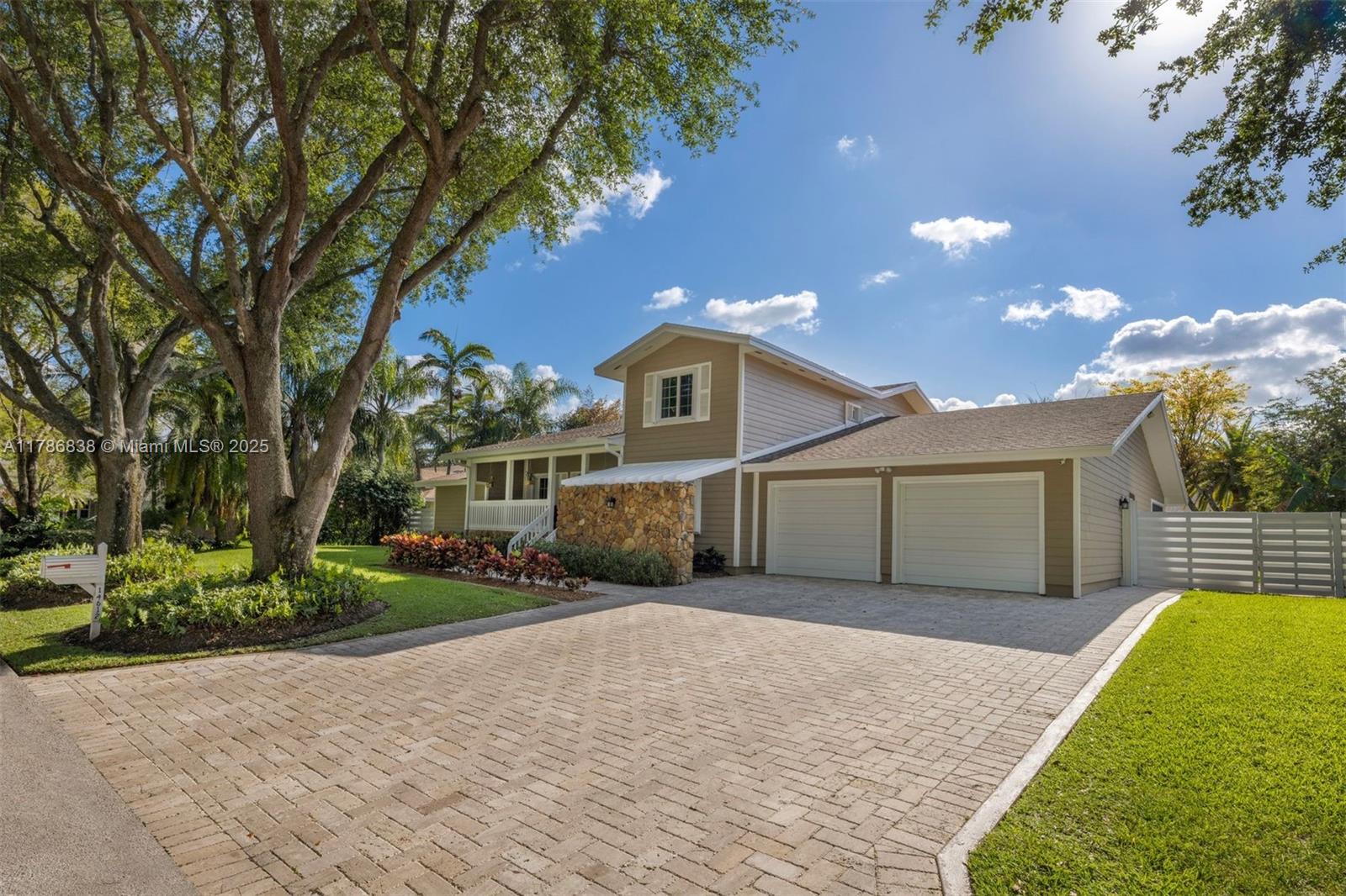 14612 Southwest 153rd Court Miami, FL 33196 - Photo 24 of 26 a front view of a house with a yard and garage
