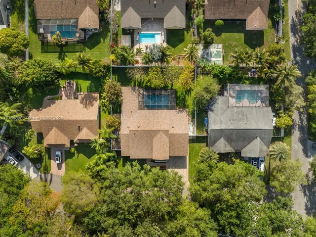 an aerial view of a house with a yard and garden