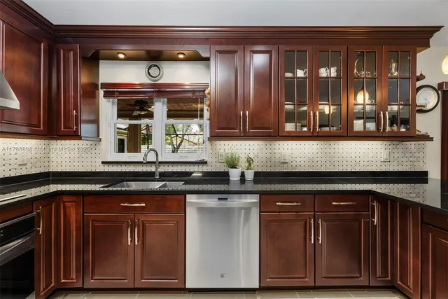 a kitchen with granite countertop wooden cabinets and a wooden floor