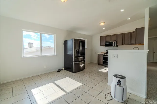 a large white kitchen with cabinets