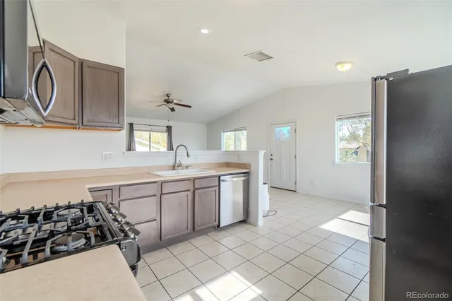 a kitchen with stainless steel appliances granite countertop a refrigerator stove and microwave