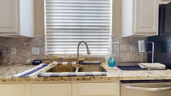 a kitchen with sink and window