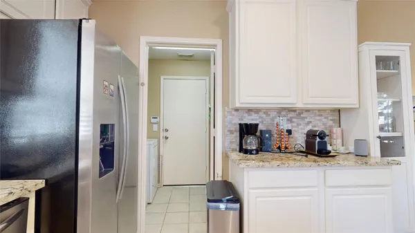 a kitchen with a refrigerator and cabinets