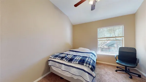 a bedroom with a bed and a chair