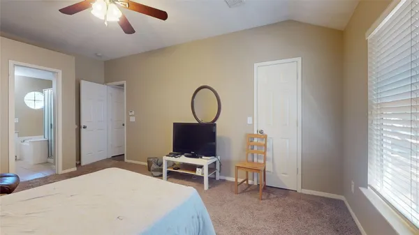 a bedroom with a bed a desk and chair