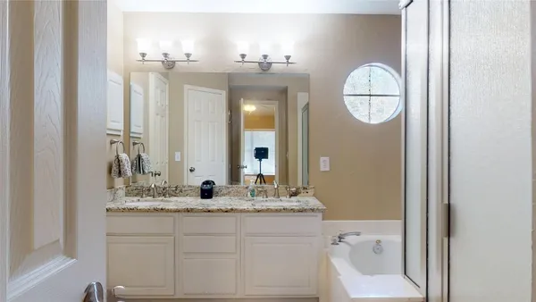 a bathroom with a granite countertop sink a toilet and a mirror