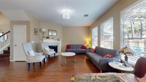 a living room with fireplace furniture and a large window